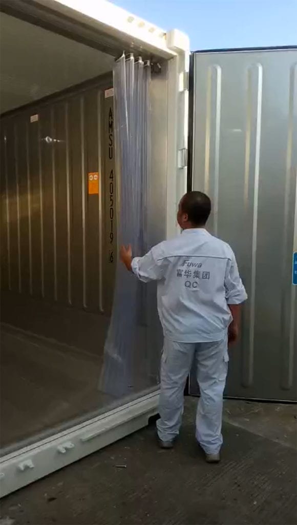Man demonstrating motion lights in walk-in refrigerated container